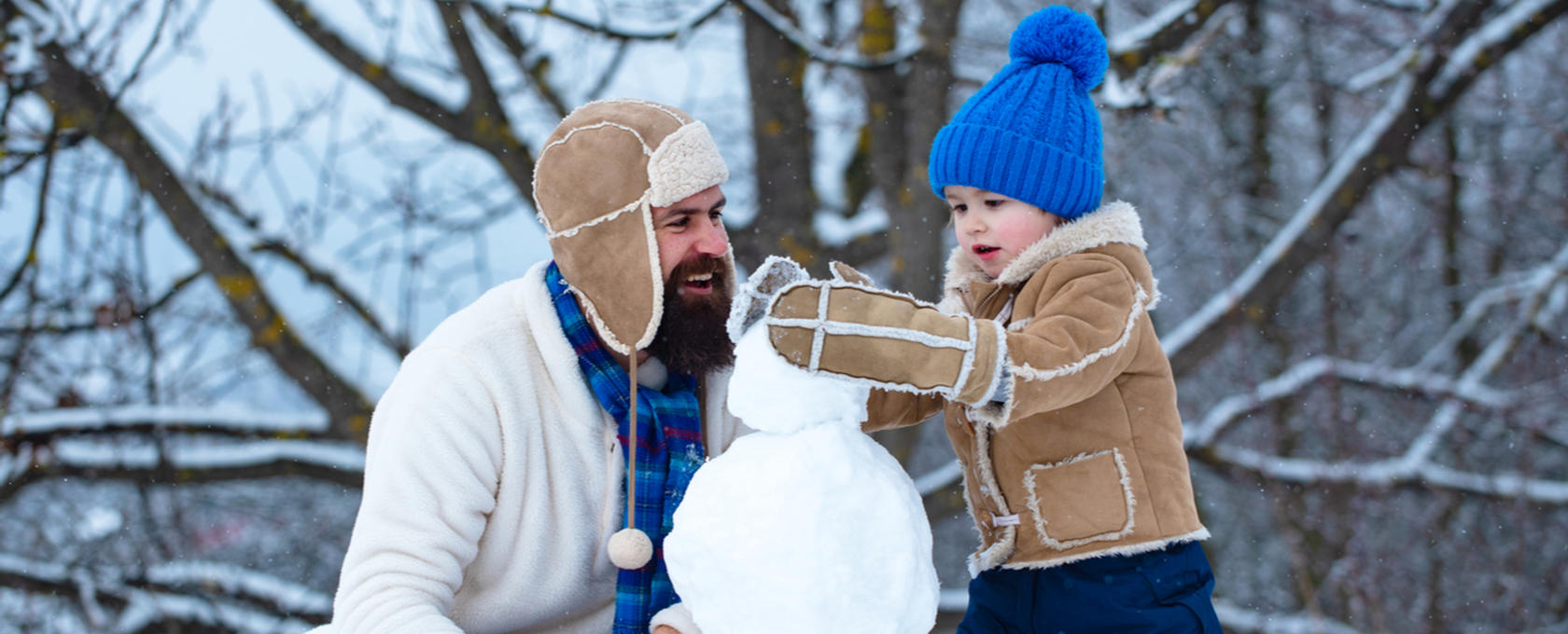 Dad and son making a snowman