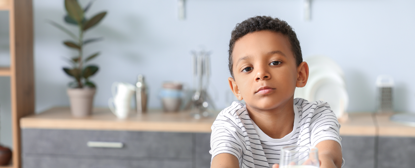 kid holding hands to say no to milk