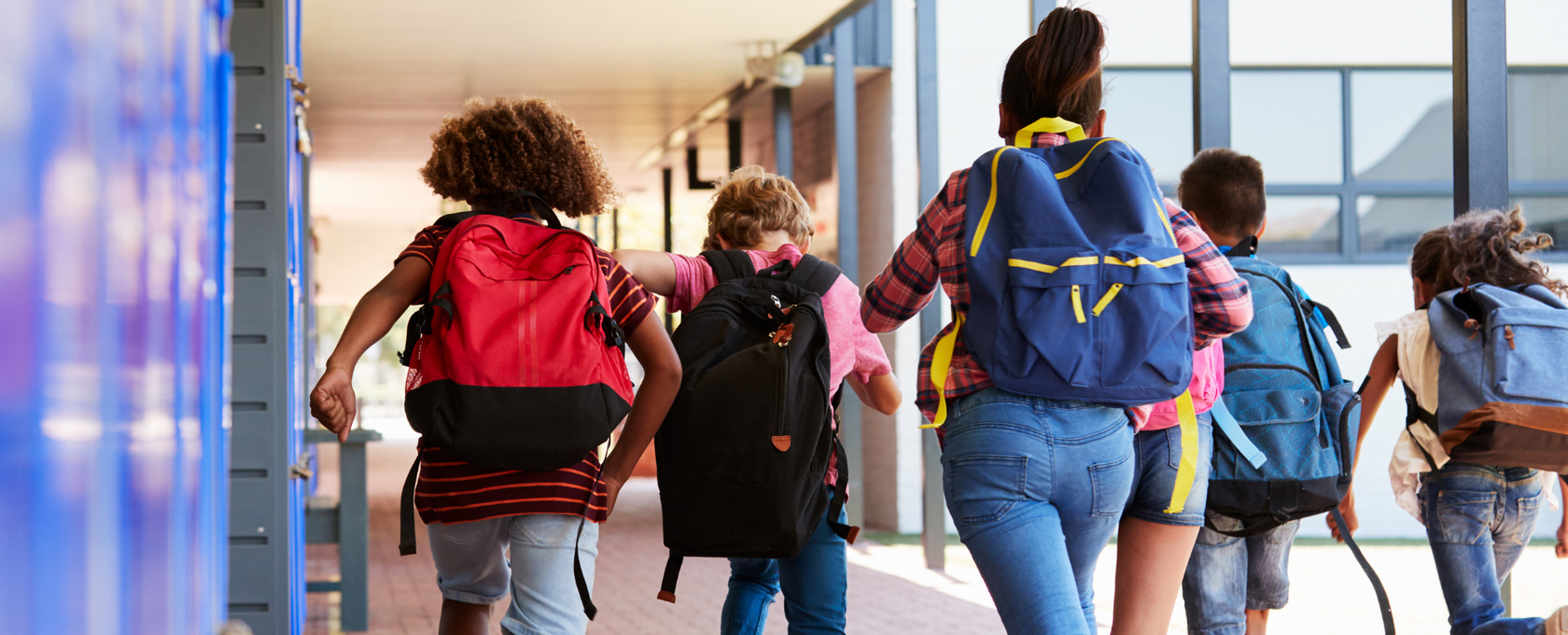 Kids running in a school hallway