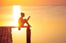 Girl reading on a dock