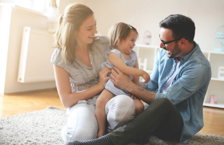 parents holding daughter