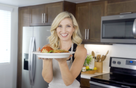 Leslie holding a plate of food smiling