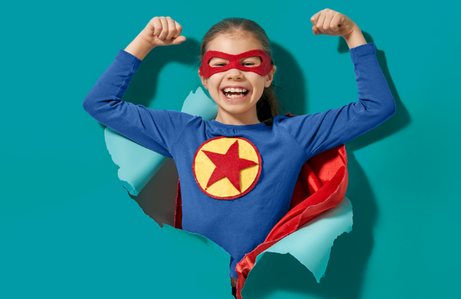 Super girl breaking through teal paper