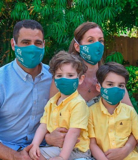 family wearing teal masks
