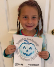 Kid holding Teal Pumpkin draing
