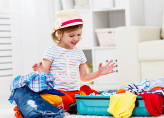 Kid packing a suitcase 