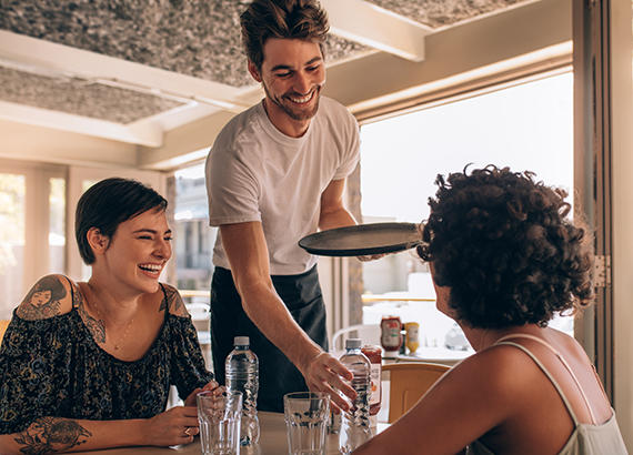 Girls talking to a waiter