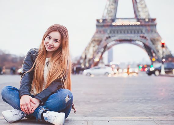 Girl sitting in front of Eiffel Tower