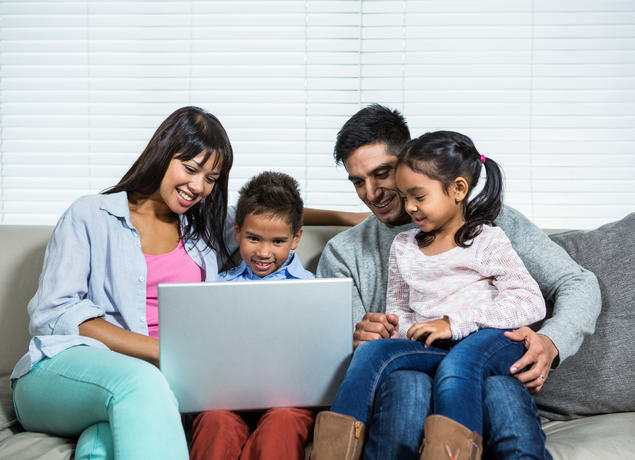 family looking at laptop