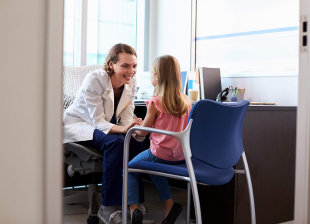 Little girl talking to doctor