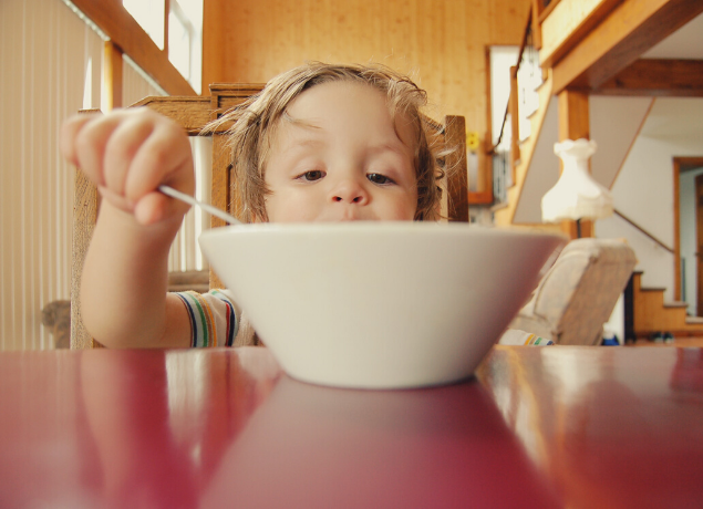 kid looking at big bowl