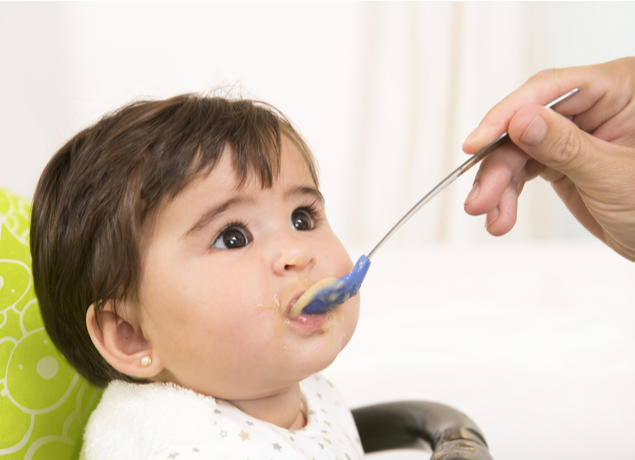 Brunette baby eating