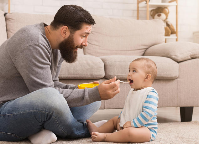 Dad feeding baby