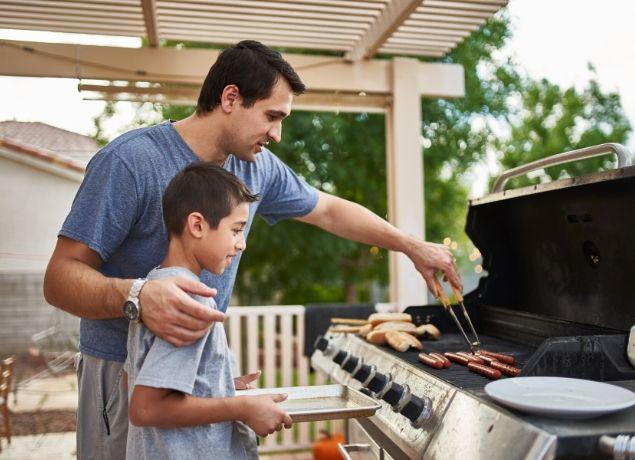 Dad and son grilling