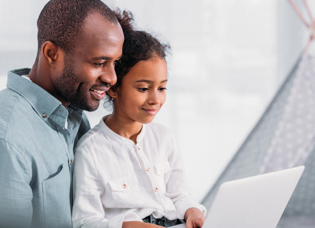 Dad and daughter on laptop