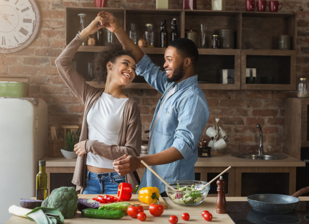 Couple dancing while cooking