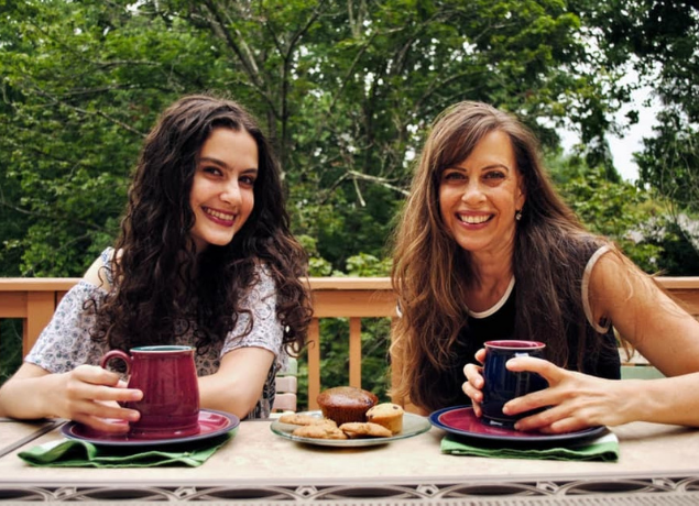 Rachel and Leah Packer with mugs eating breakfast