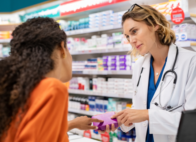 pharmacist talking to a woman about her medication