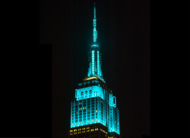 Empire State Building shining teal