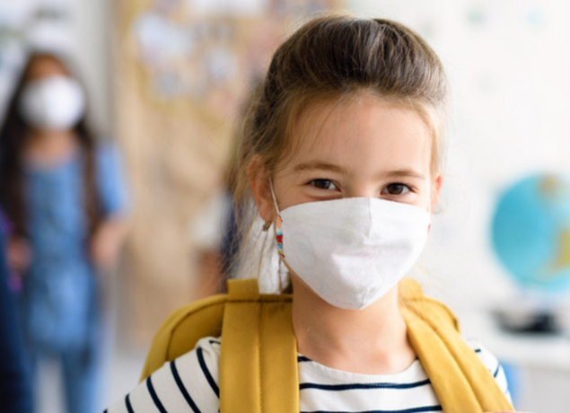 Girl in a mask at school