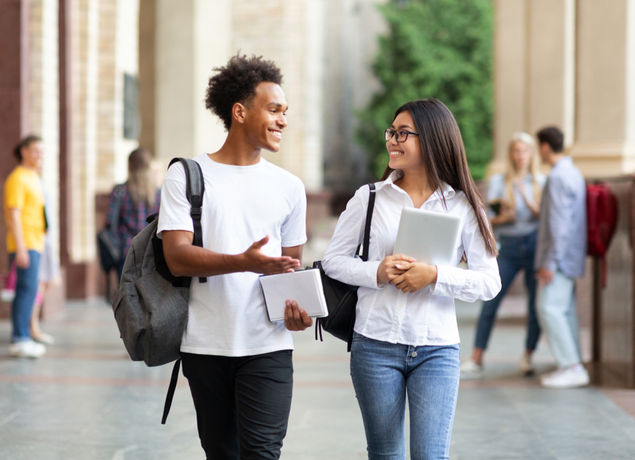 Two people talking at college