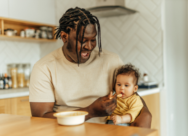 Dad feeding a baby
