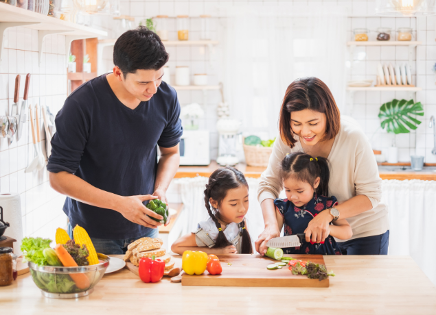 Family chopping veggies