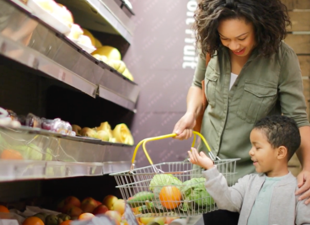 Mom grocery shopping with her son