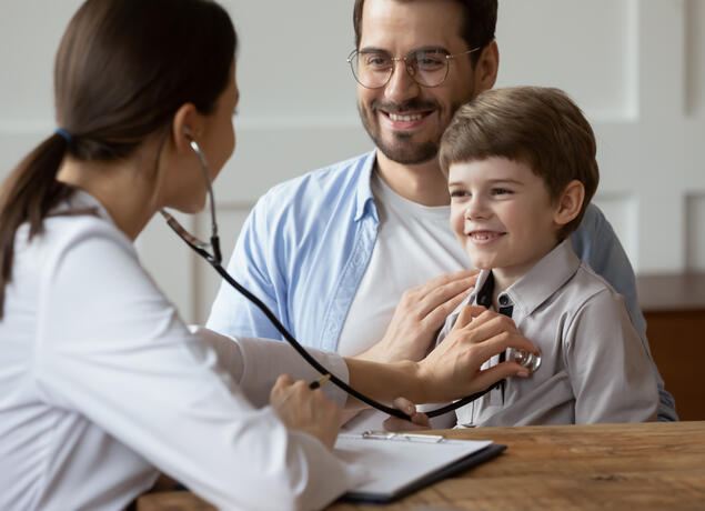 Doctor and father with young patient