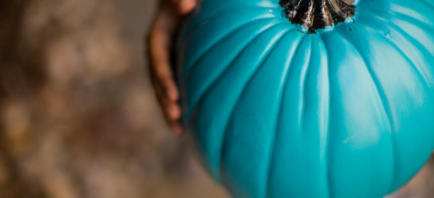 Teal Pumpkin in Hands