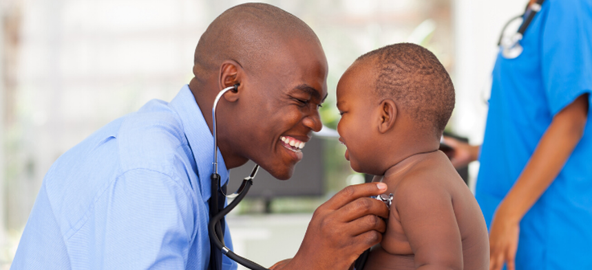 doctor examining infant
