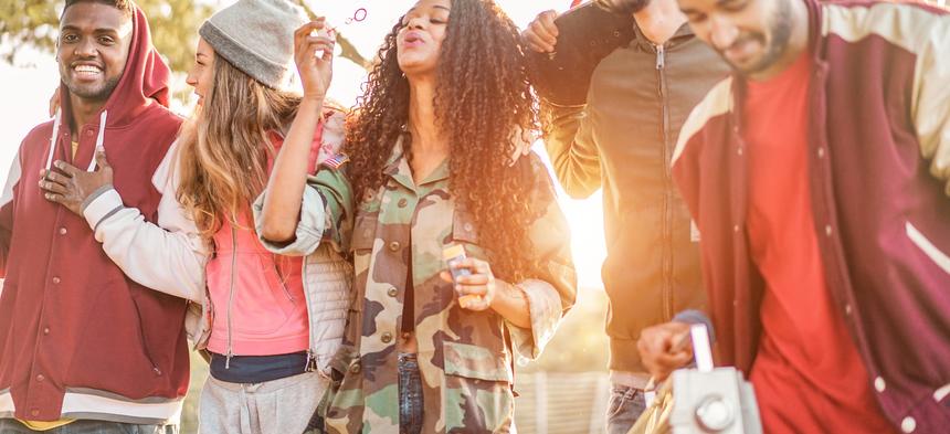 young adults blowing bubbles