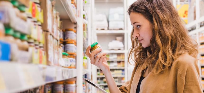 woman reading food label