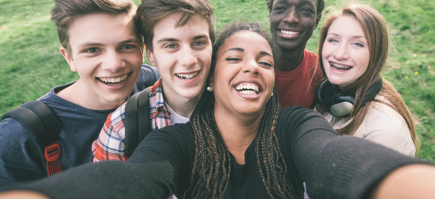 Teens taking a group selfie