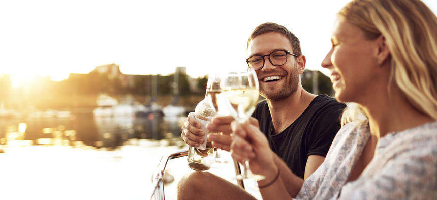 adults clinking wine glasses