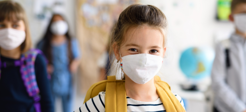 Girl in a mask at school