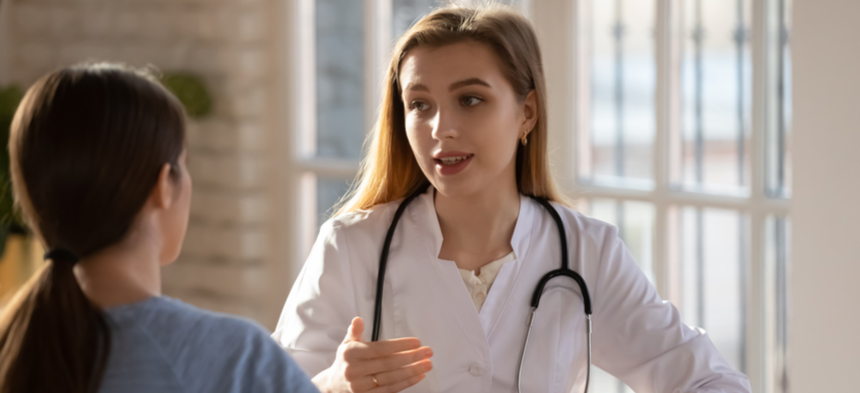 Girl talking to physician