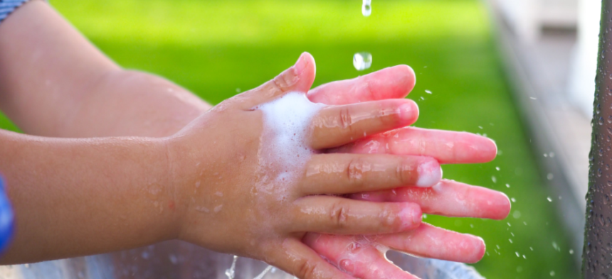 little kid washing hands